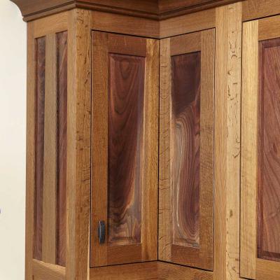 fumed oak and crotched walnut paneled cabinets in Arts & Crafts style